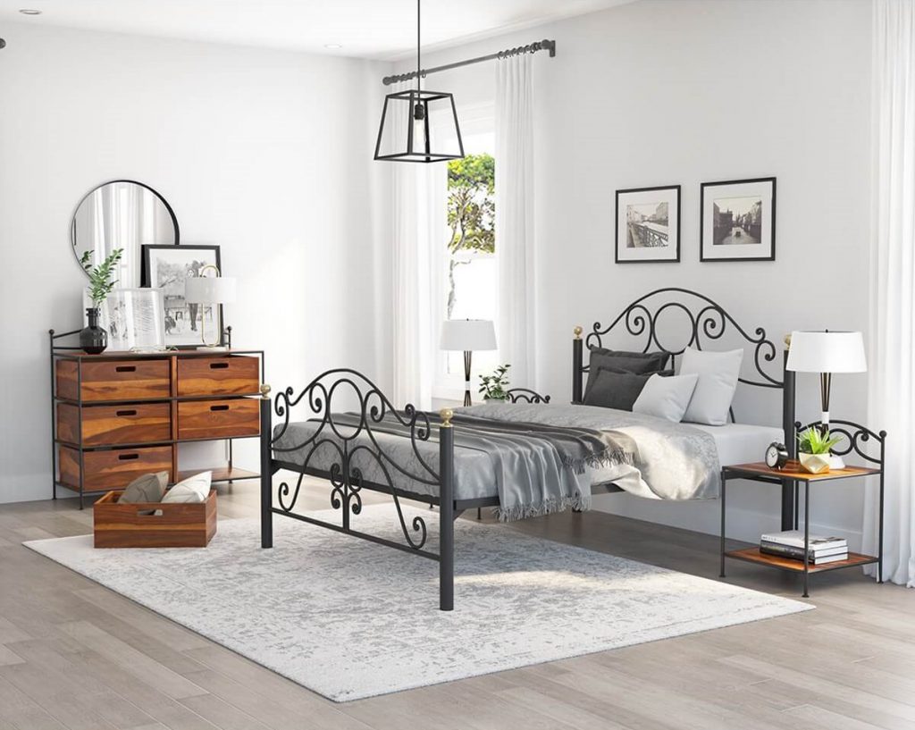 black painted Wrought Iron Bed white painted walls and placed 6 drawer dresser near bed
