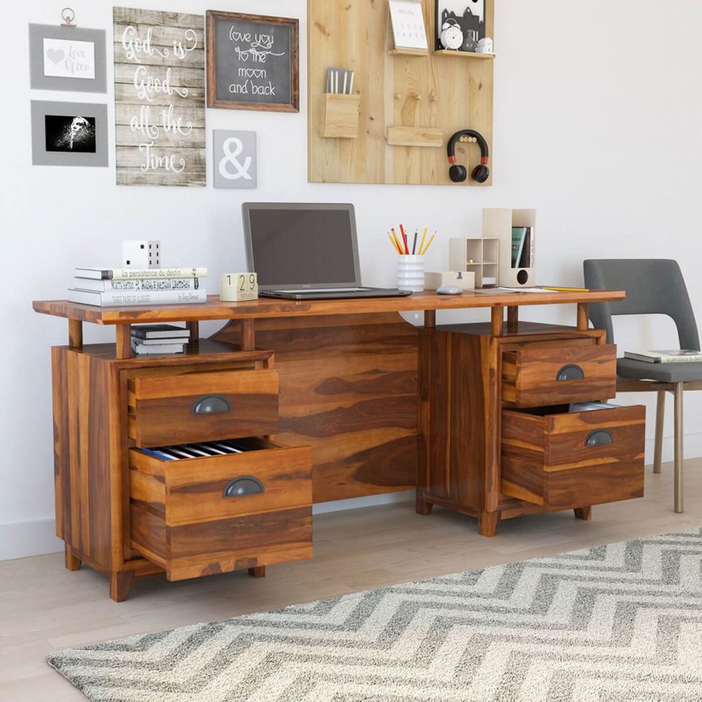 solid wood desk with open drawers having stationery items on top