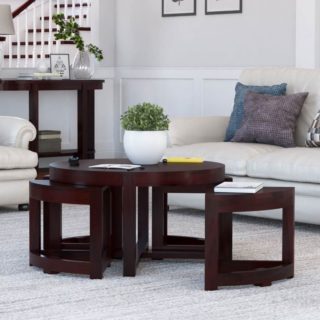 Solid wood round coffee table with stools placed in living room