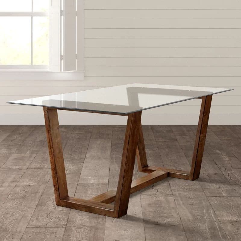 Rustic modern table with sleek glass top and wooden frame base 