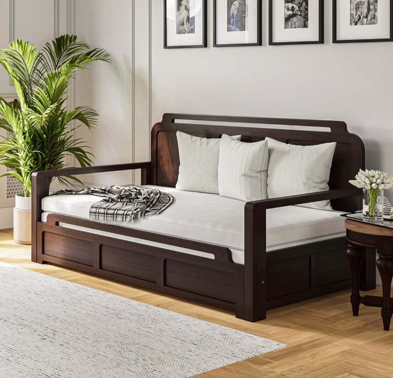 Sleeper sofa partially converted into a bed in a small apartment living room, multifunctional space, cozy bedding, nighttime warm lighting, compact modern interior