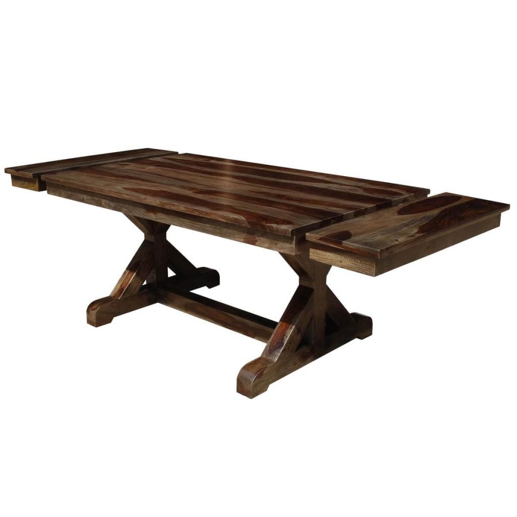 Extendable wood dining table with an X-shaped trestle base.