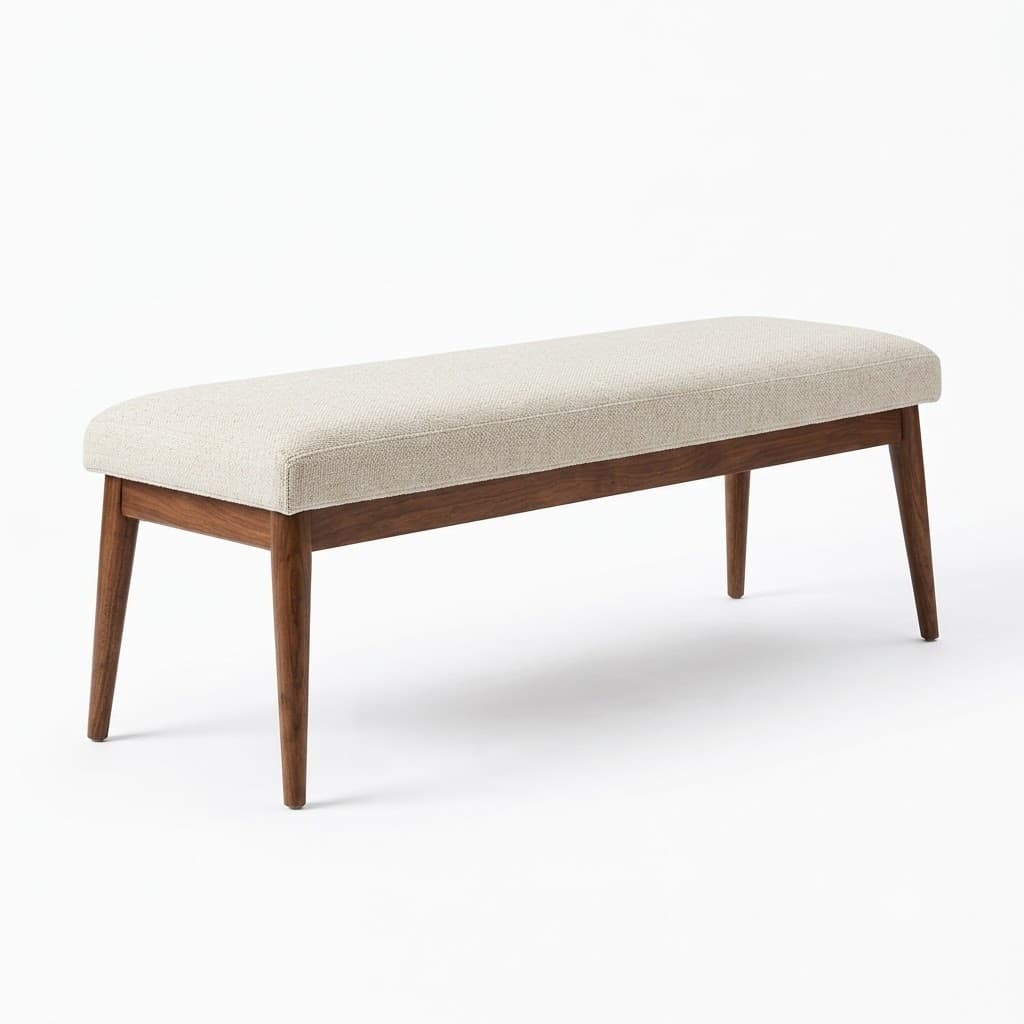 Upholstered dining bench with tapered walnut legs.
