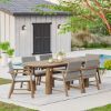 Picture of Collier Teak Outdoor Oval Dining Table with Rattan Armchair Set